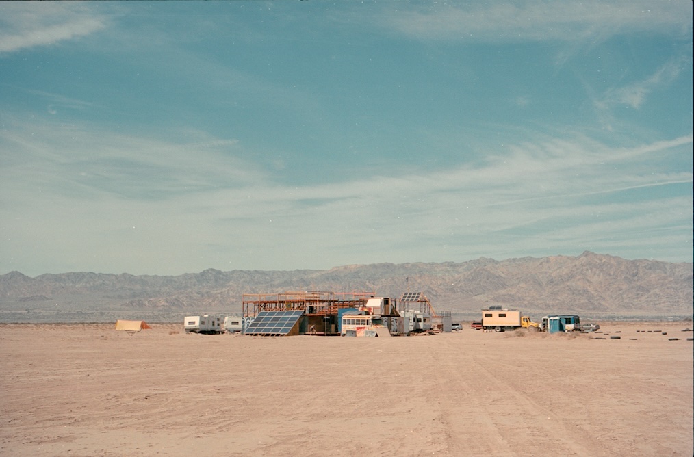 A wide shot of the Mars College settlement against a mountain backdrop.