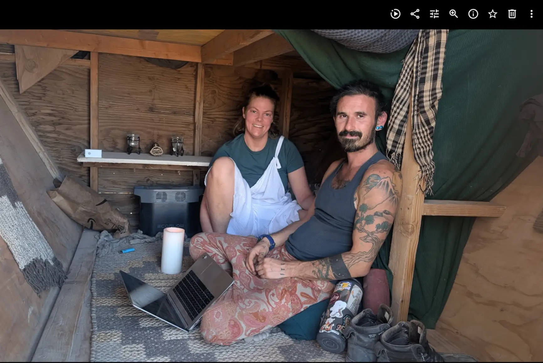 Two campmates inside a wooden shelter
