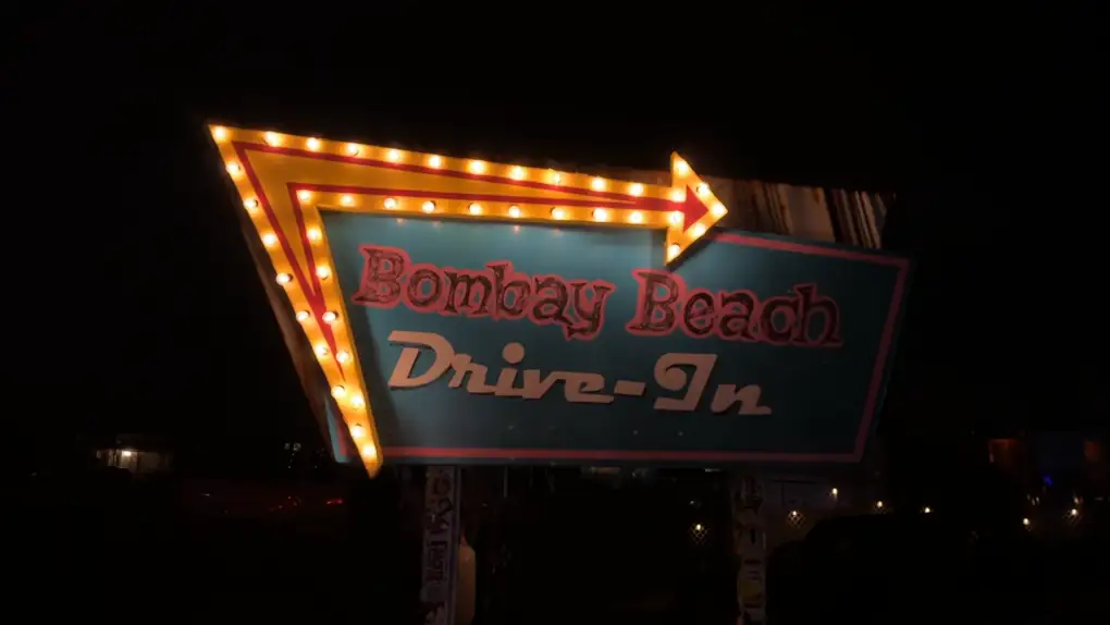 The illuminated Bombay Beach Drive-In marquee on festival night · 2023