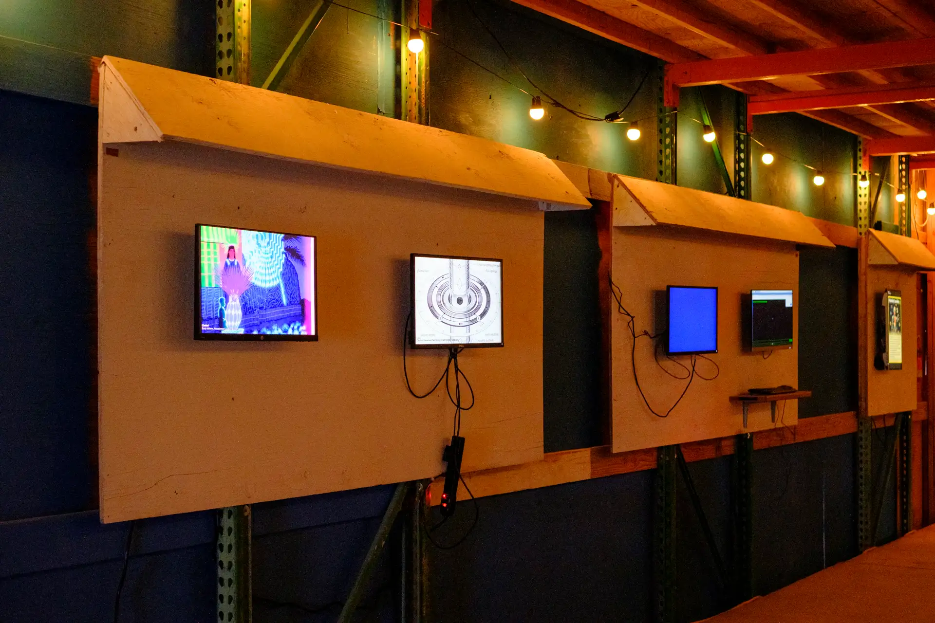 A row of screens running generative work · 2026
