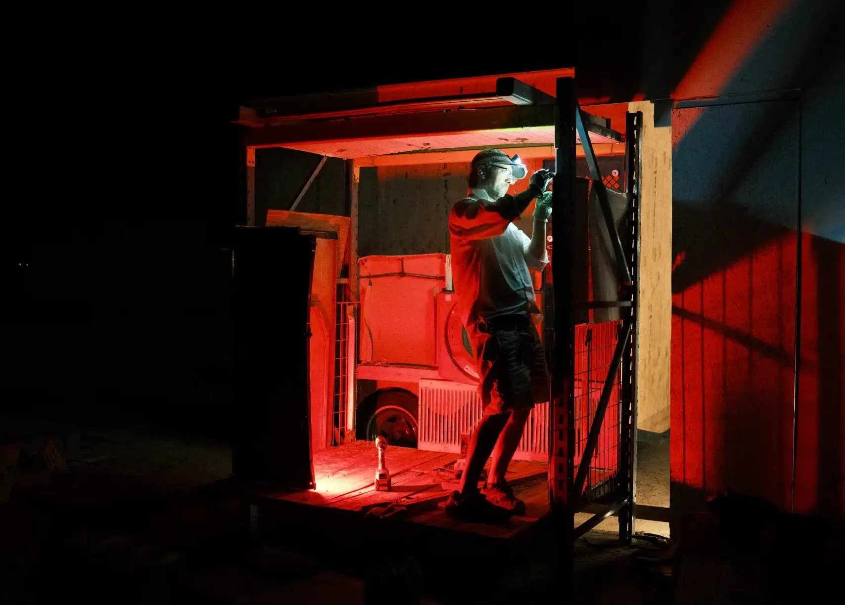 Night work under a red headlamp glow