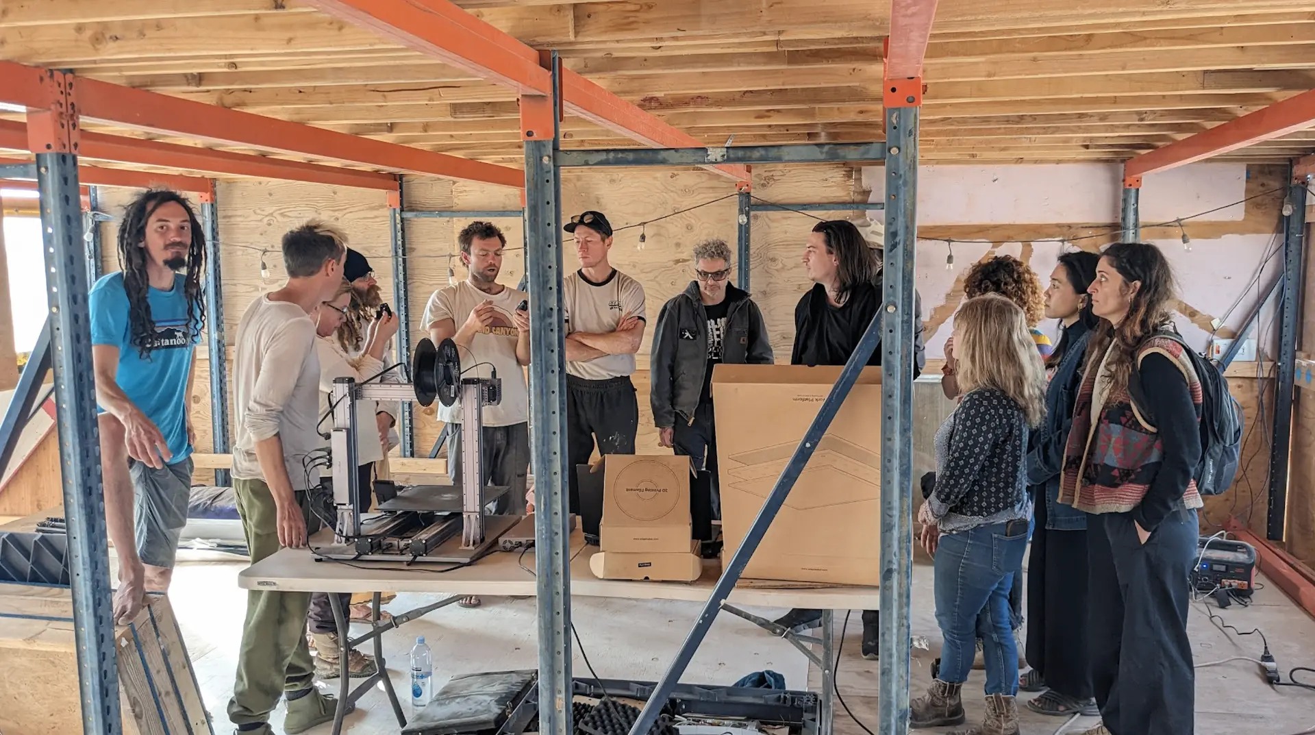 The camp gathered around a 3D-printer demo inside the DEC workshop